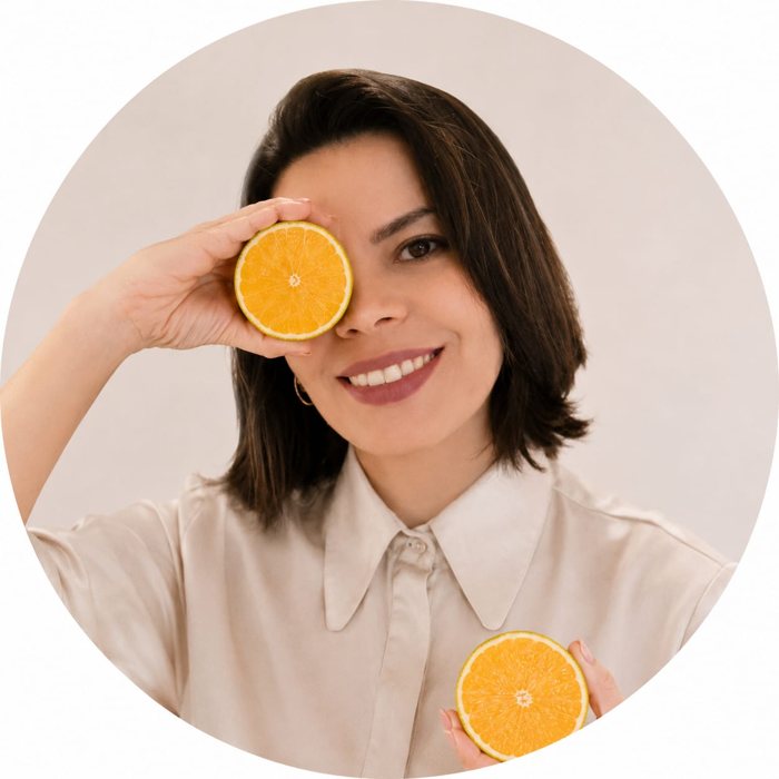 Priscila Schunck segurando uma laranja